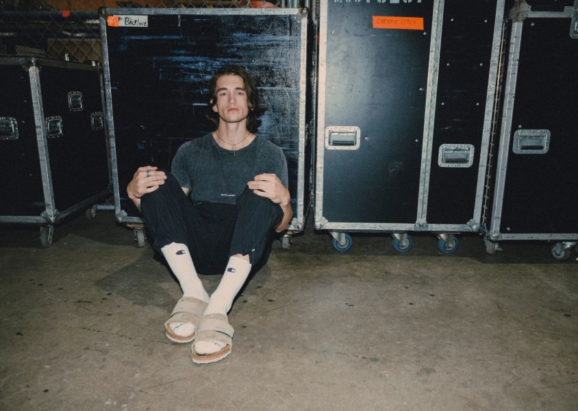 Chance Pena sat in front of some flight casesx